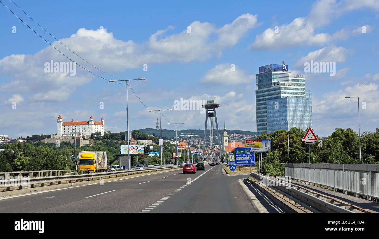 Bratislava, Slovakia - July 10, 2015: Castle and SNP Bridge With Restaurant on Top of Pylon in Bratislava, Slovakia. Stock Photo