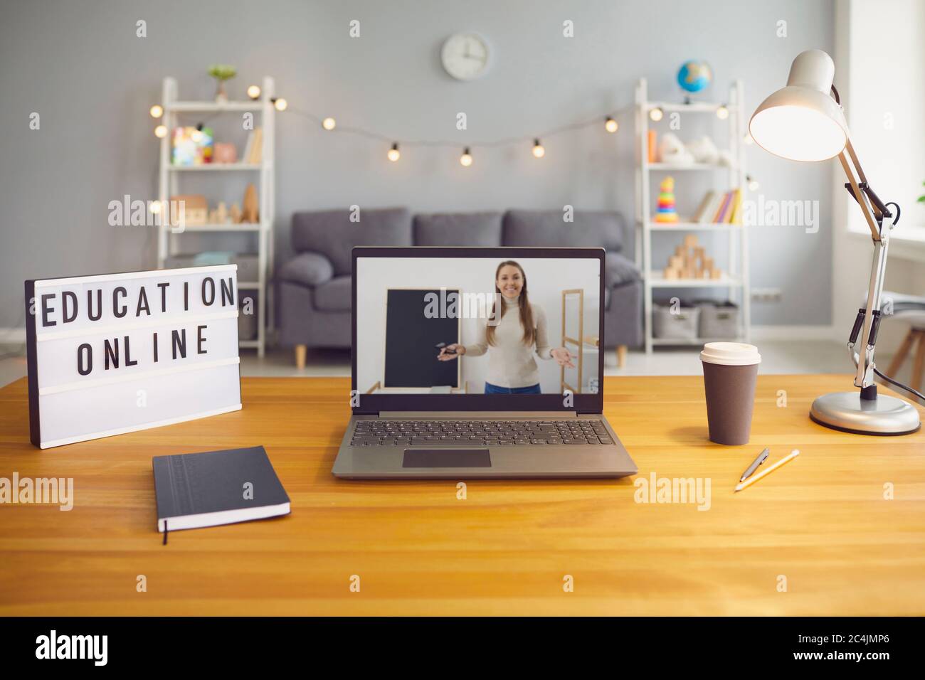 Online education. Laptop computer with young teacher giving class