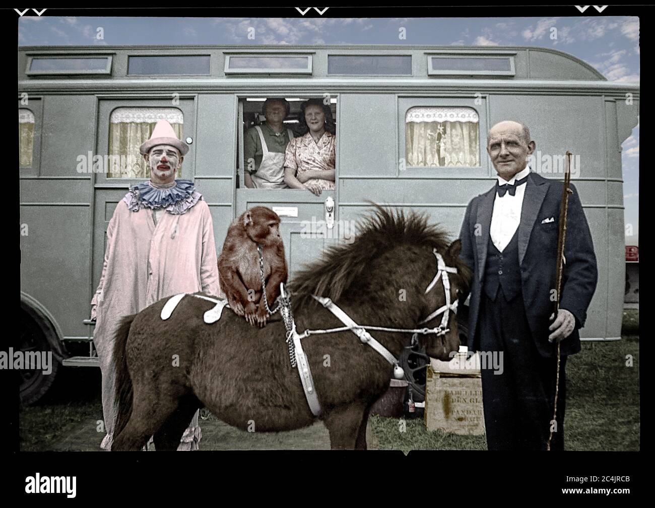 Circus trailer with performers in England, 1948. Image colorized from 6x9 cm B&W negative. Stock Photo