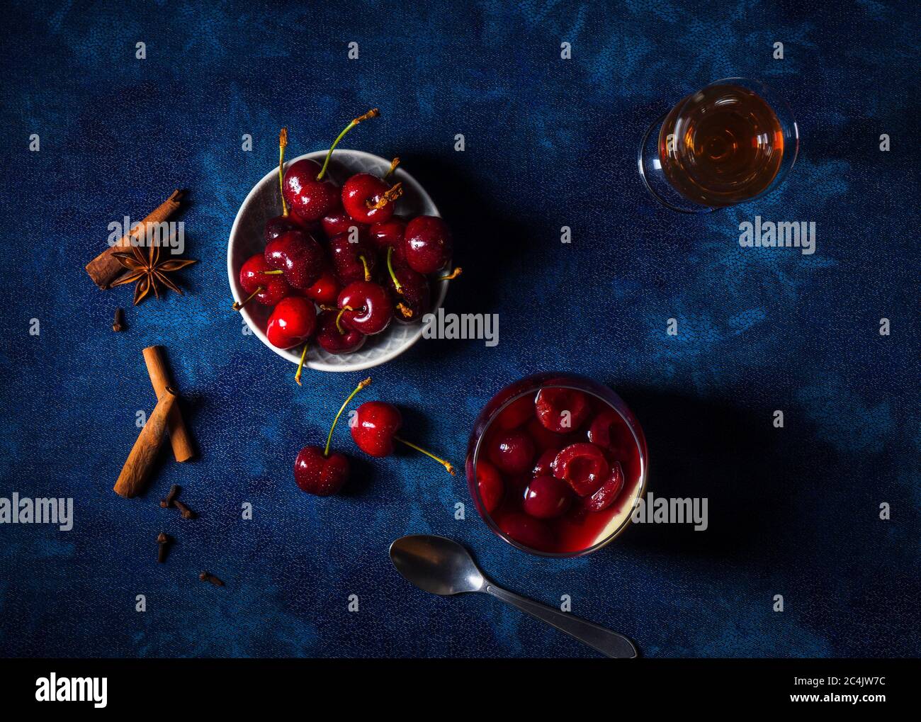 Panna cotta Italian traditional dessert with cherries poached in rum