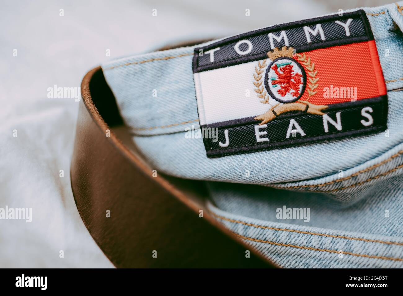 Closeup of Tommy Hilfiger label on blue jeans Stock Photo - Alamy