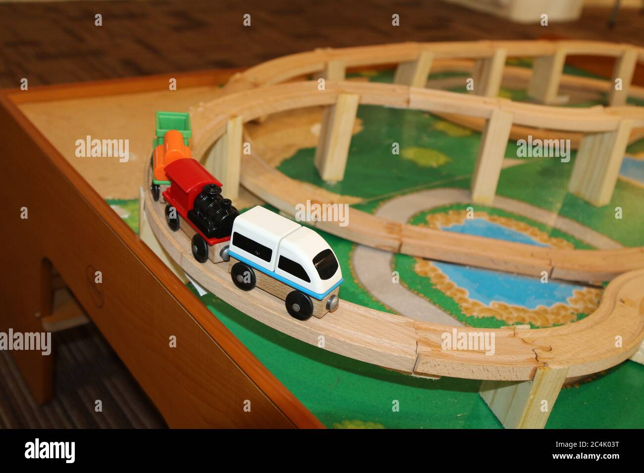 Toy train running on wooden tracks Stock Photo Alamy