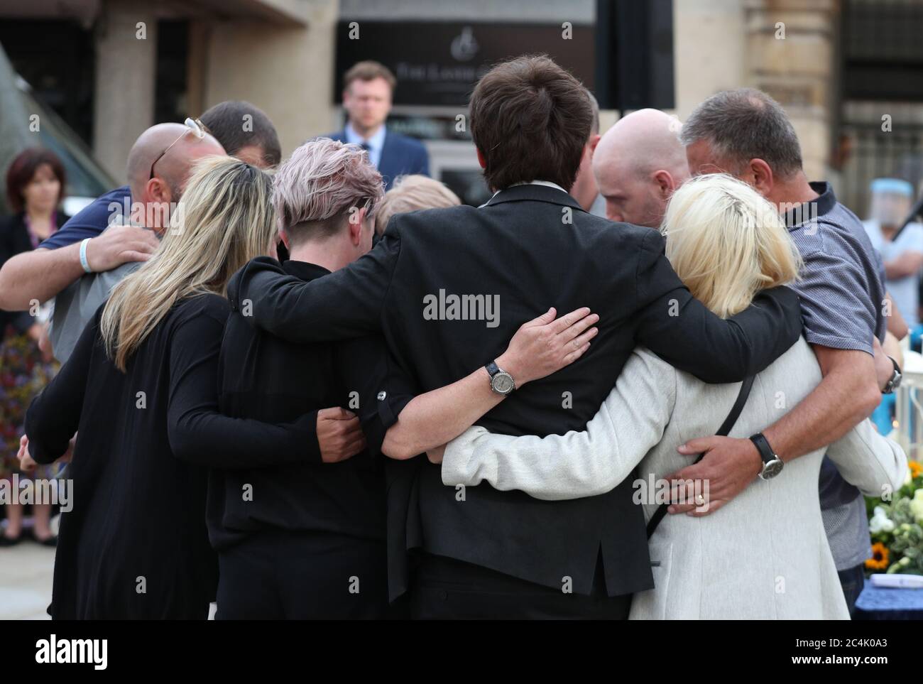 Family members of the three victims comfort each other after lighting candles during a vigil at Market Place, Reading, in memory of David Wails, Joseph Ritchie-Bennett and James Furlong, who were killed in the Reading terror attack in Forbury Gardens in the town centre, shortly before 7pm on June 20. Stock Photo