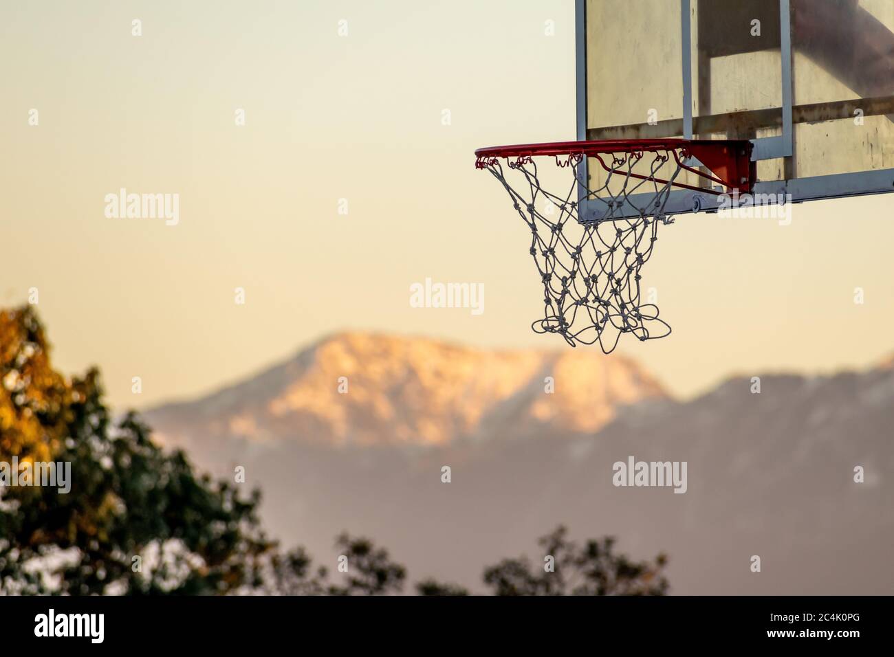 A basketball hoop with the mountain range in the background; Chail
