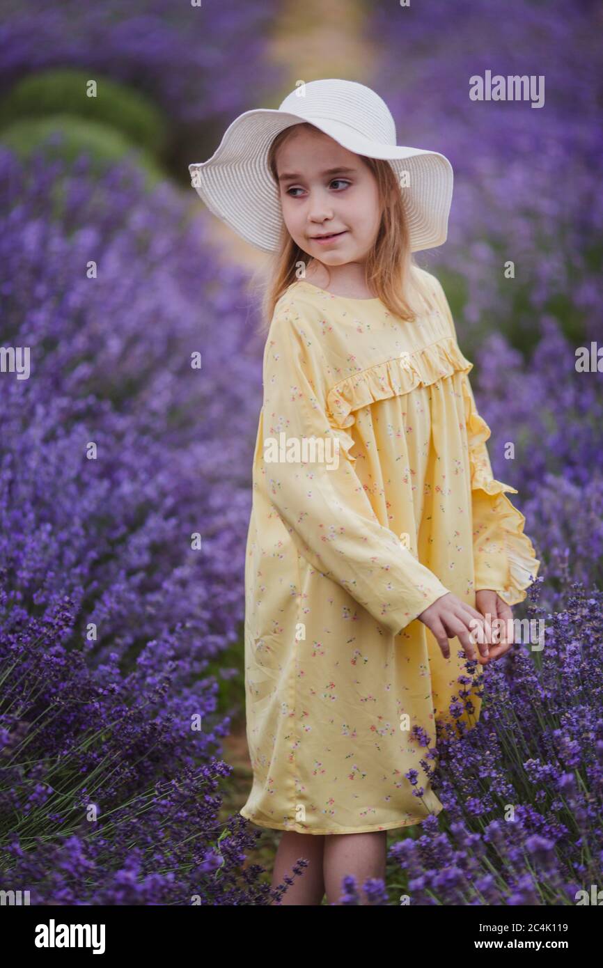 Smiling small girl in yellow dress and 