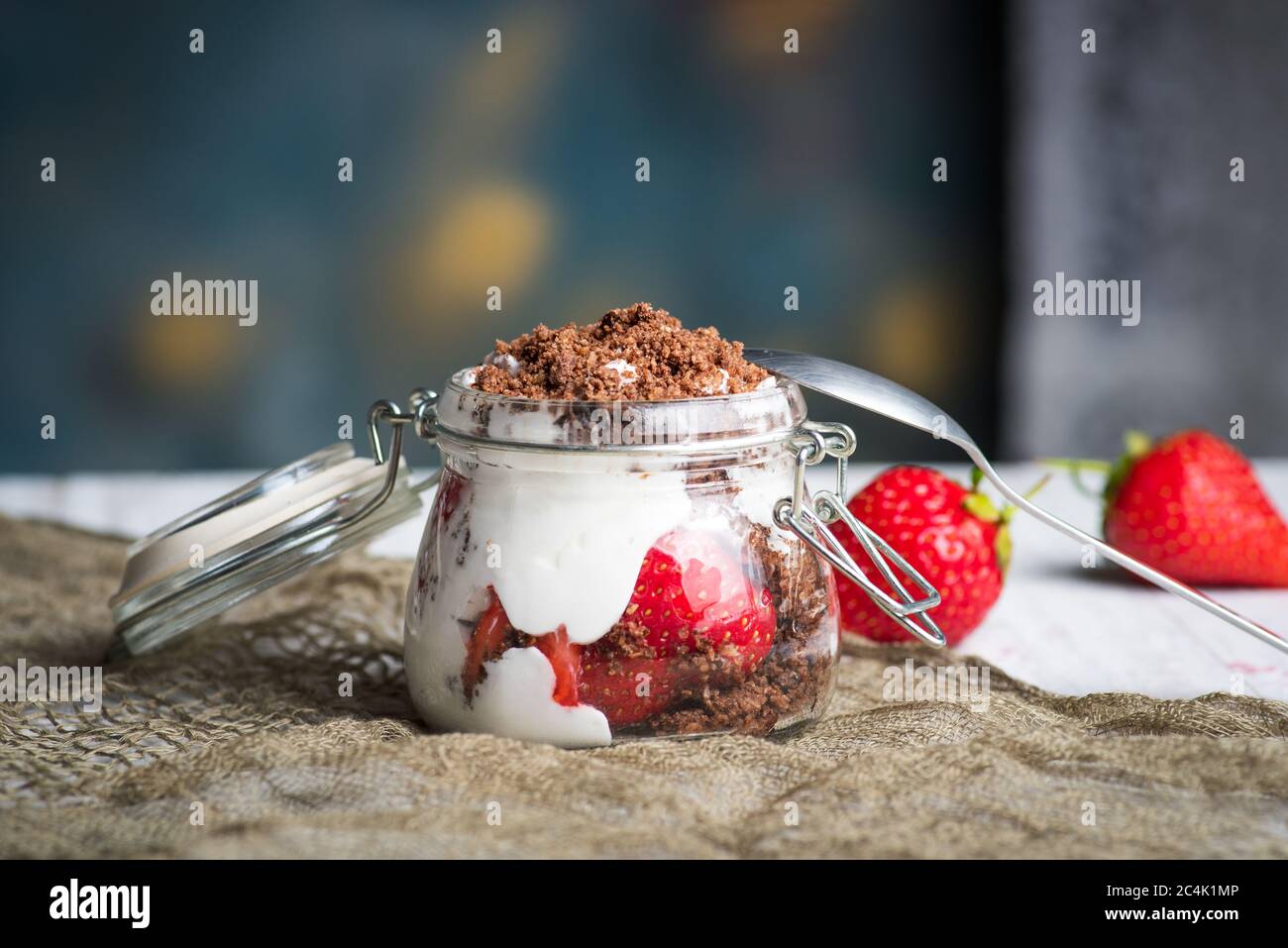 Strawberry parfait dessert in a glass jar closeup Stock Photo