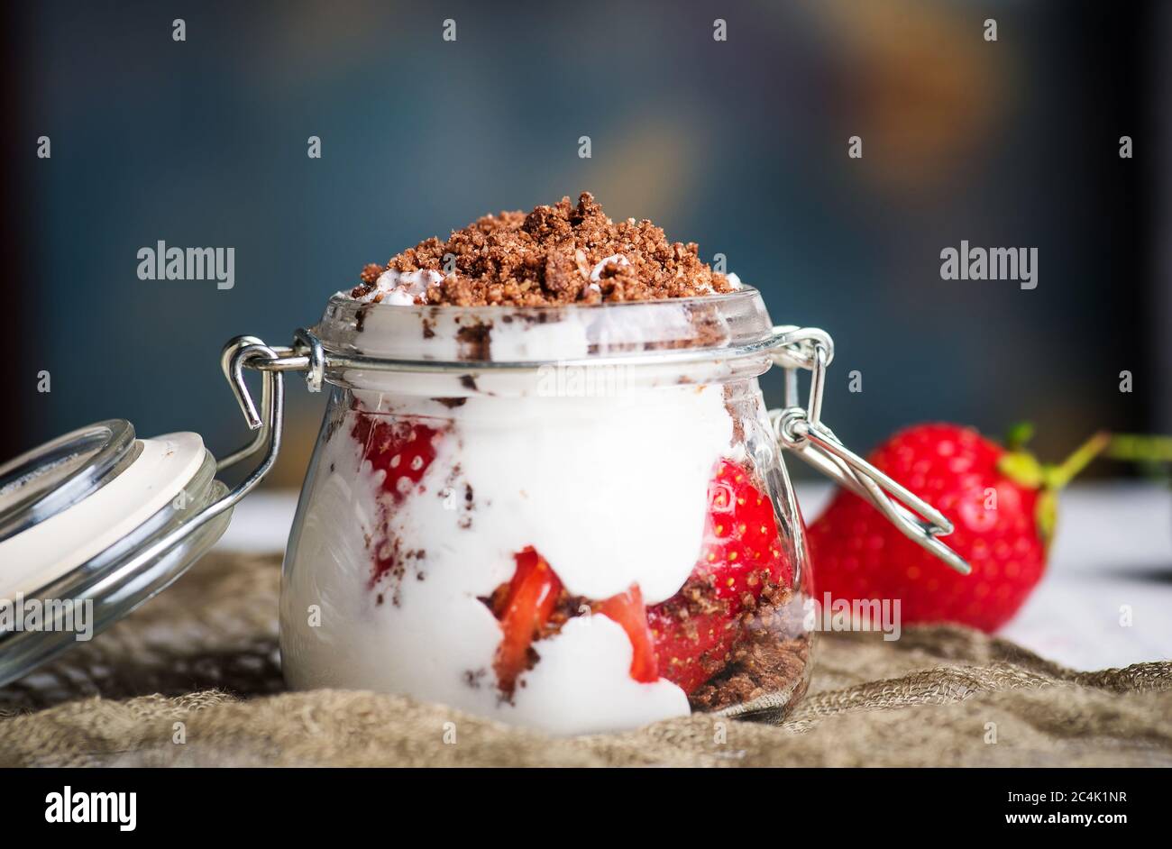 Strawberry parfait dessert in a glass jar closeup Stock Photo