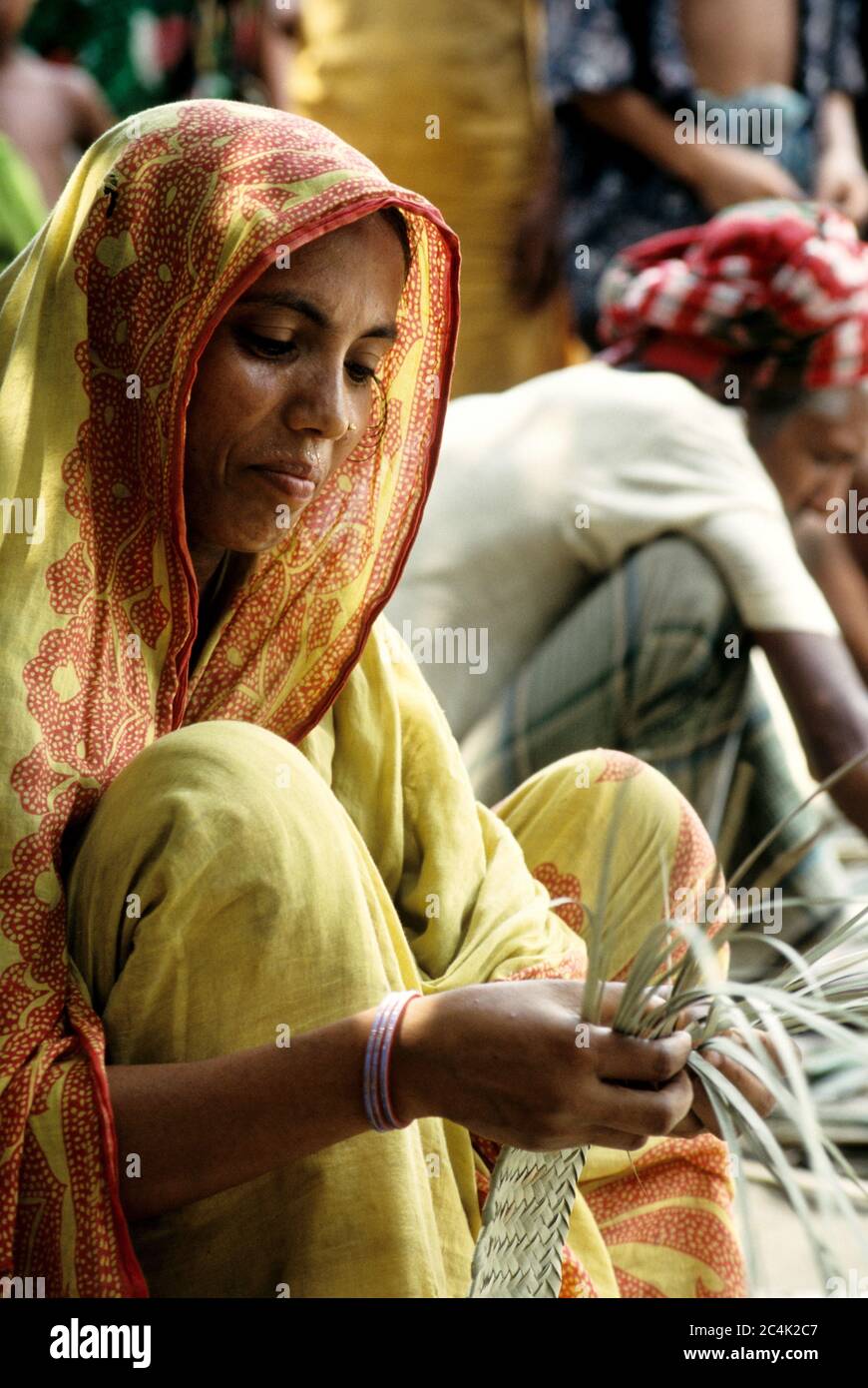 A woman works with the stems of some palm or coconut leaves used in weaving  to make some wonderful handicrafts or household items. Bangladesh Stock  Photo - Alamy