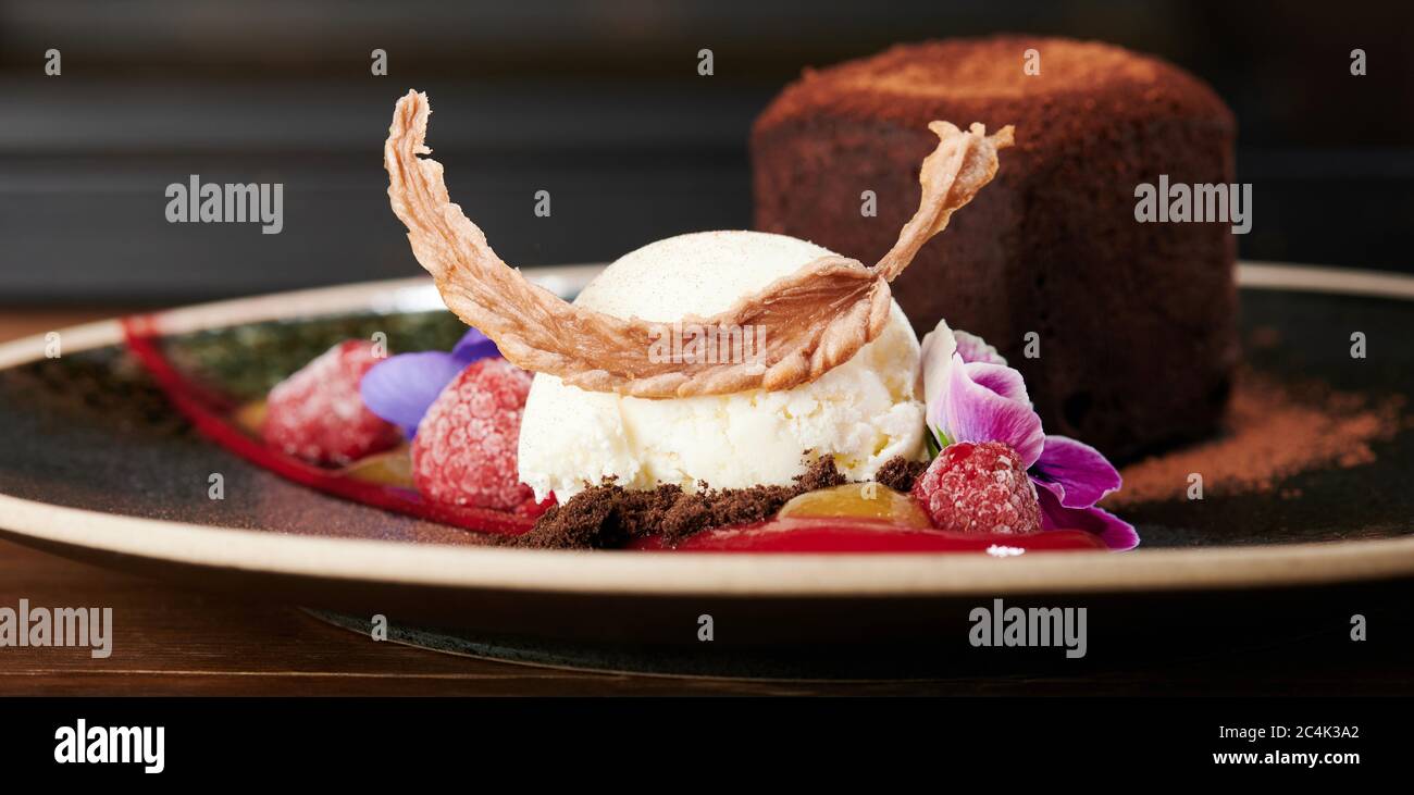 Scoop of ice cream with fruits and brownie close up view Stock Photo