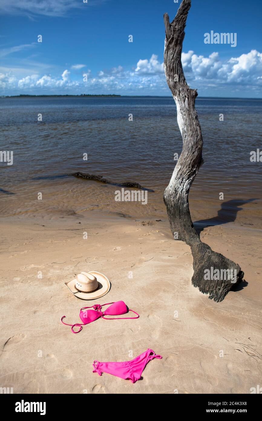 Bikini and Cowboy hat left on beach scene Stock Photo