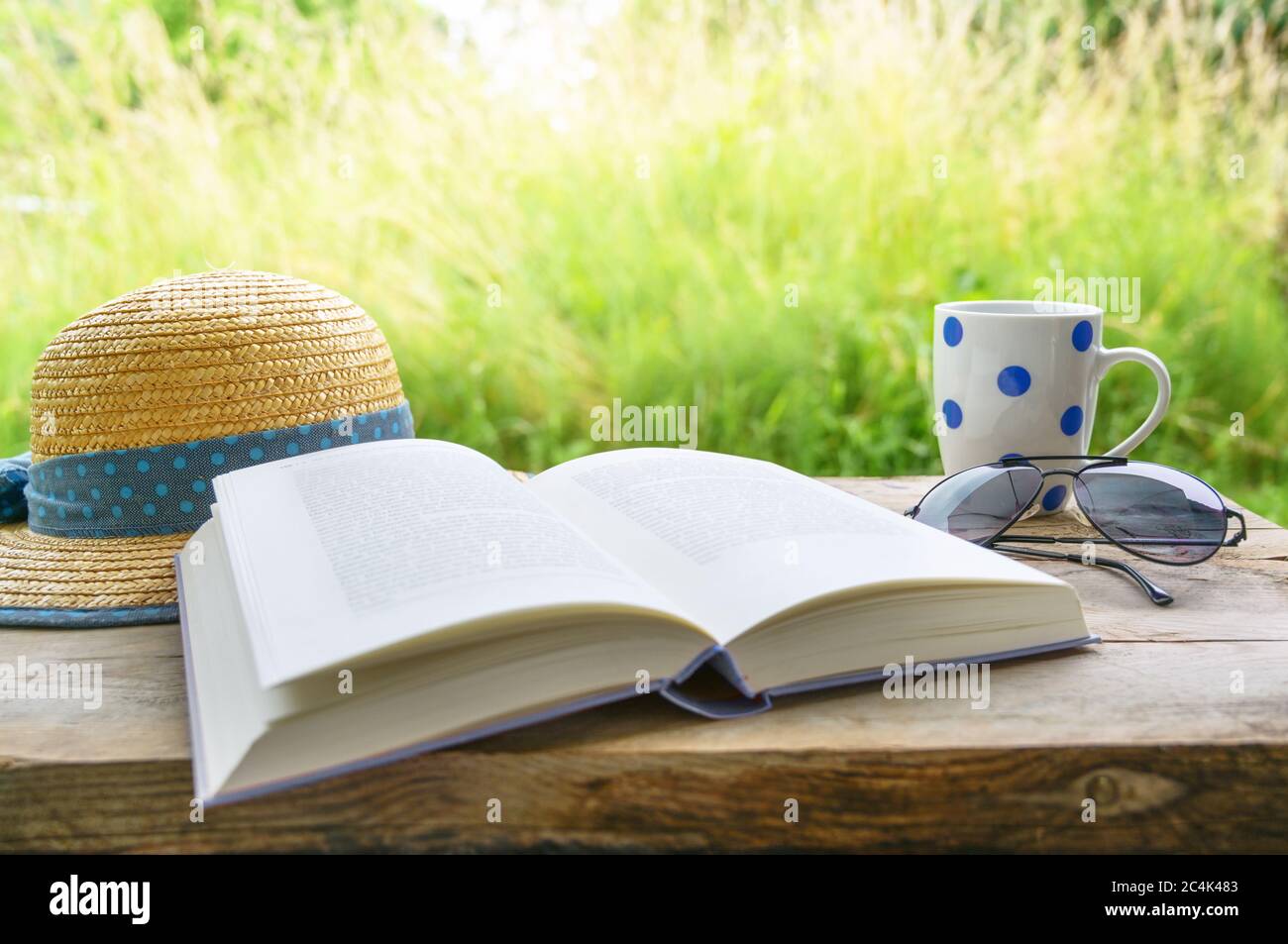 sun glasses, coffee mug and straw hat 