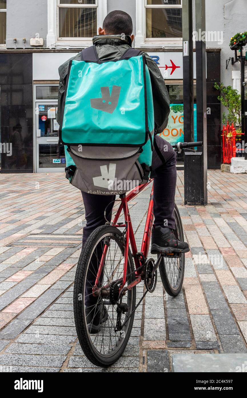 Deliveroo Food Delivery Rider in Cork City, Ireland. Stock Photo