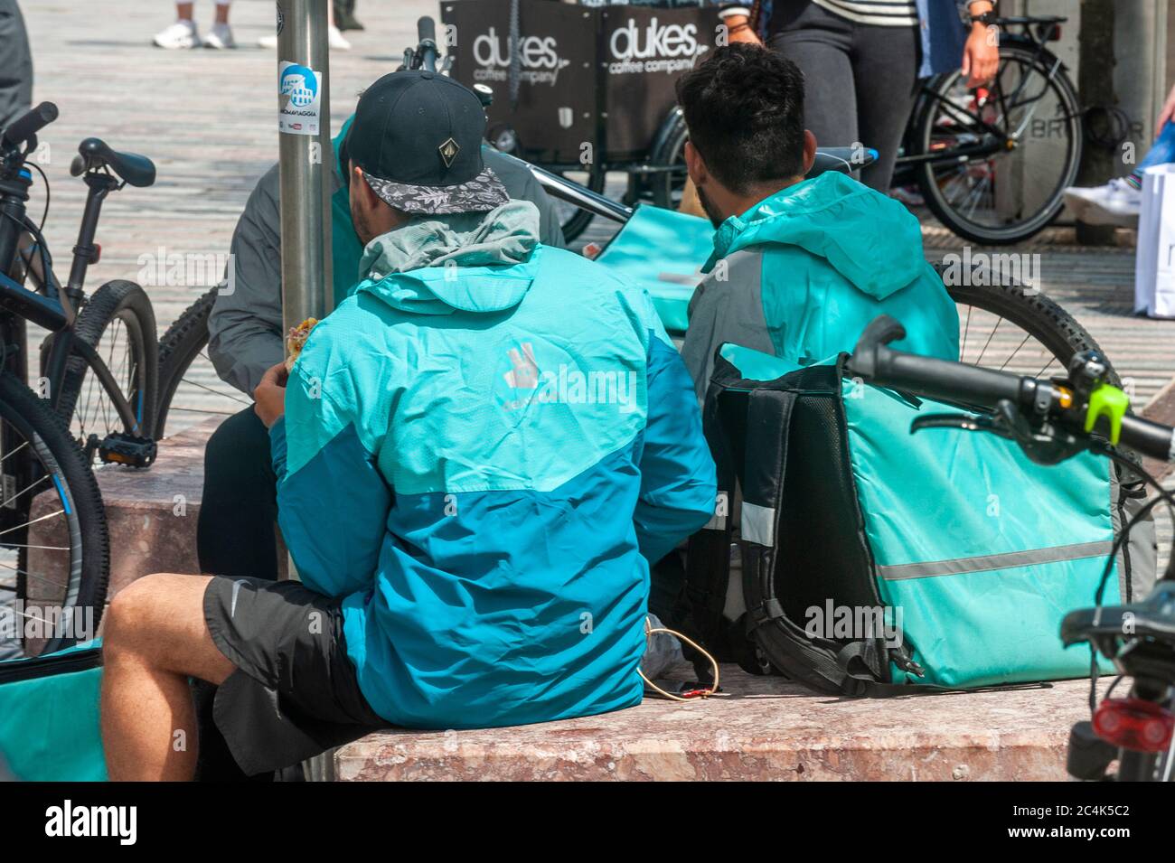Deliveroo Food Delivery Riders in Cork City, Ireland. Stock Photo