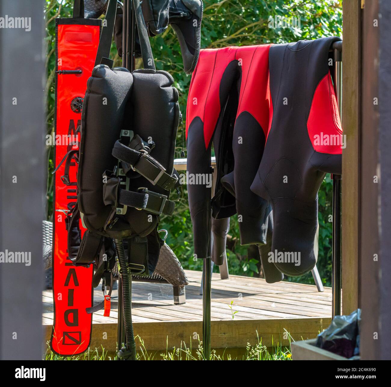 Scuba diving equipment hanging up to dry in a garden after a scuba dive. Picture from Scania, southern Sweden. Diving in cold water Stock Photo