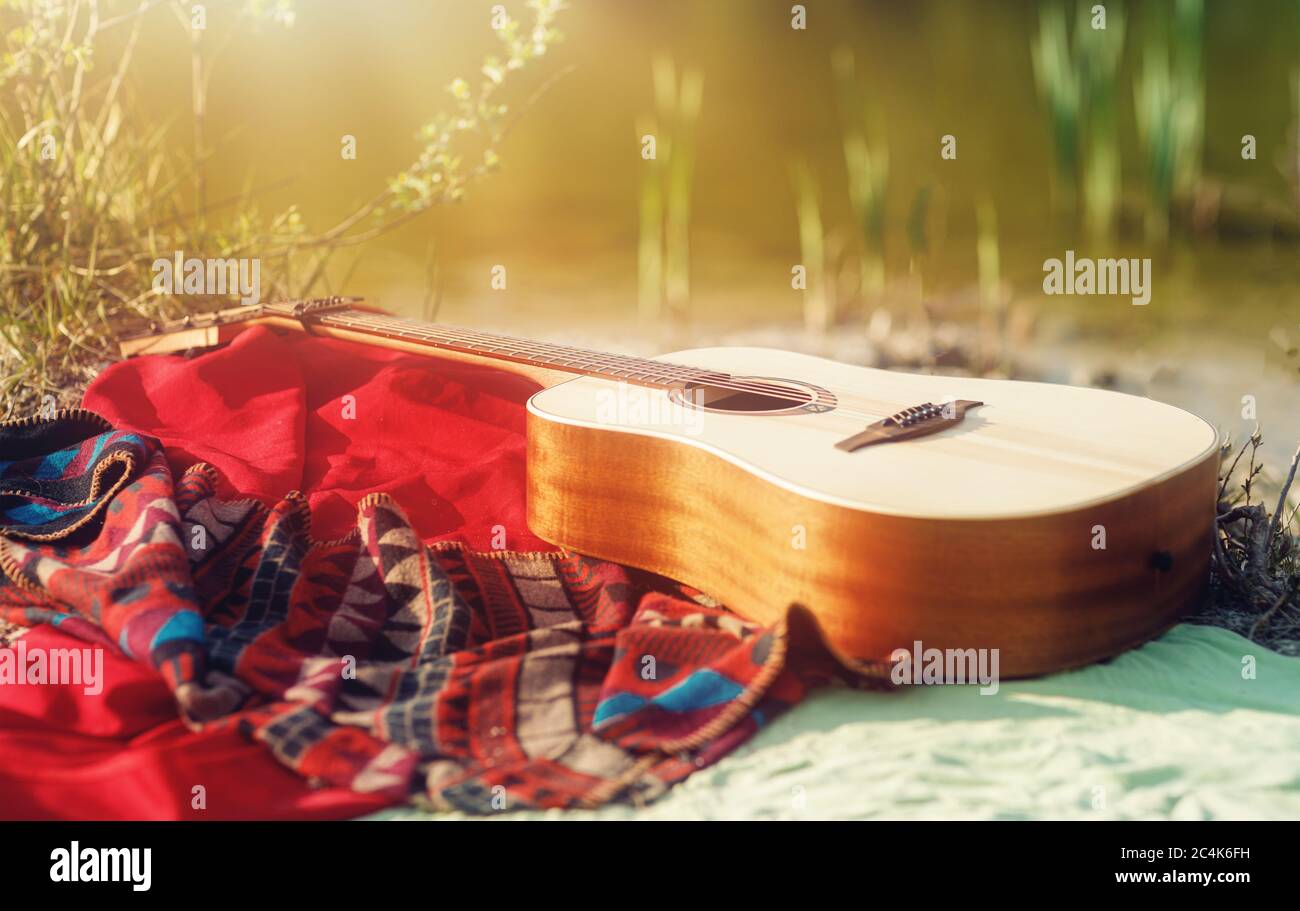 guitar on a blanket on the ground in nature Stock Photo Alamy