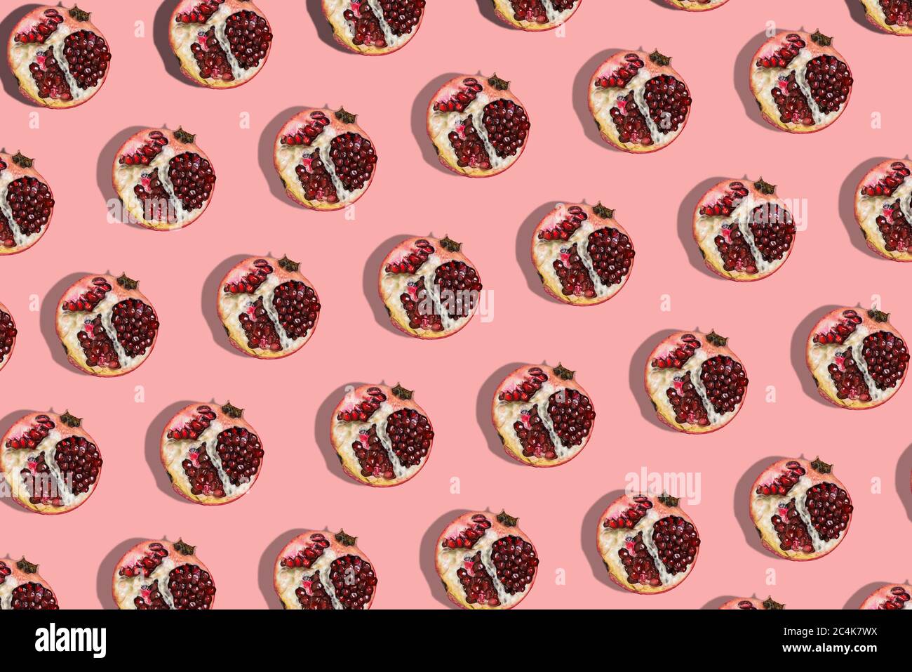 Red garnet on a pink background. Fashion seamless models. Fruit template Stock Photo