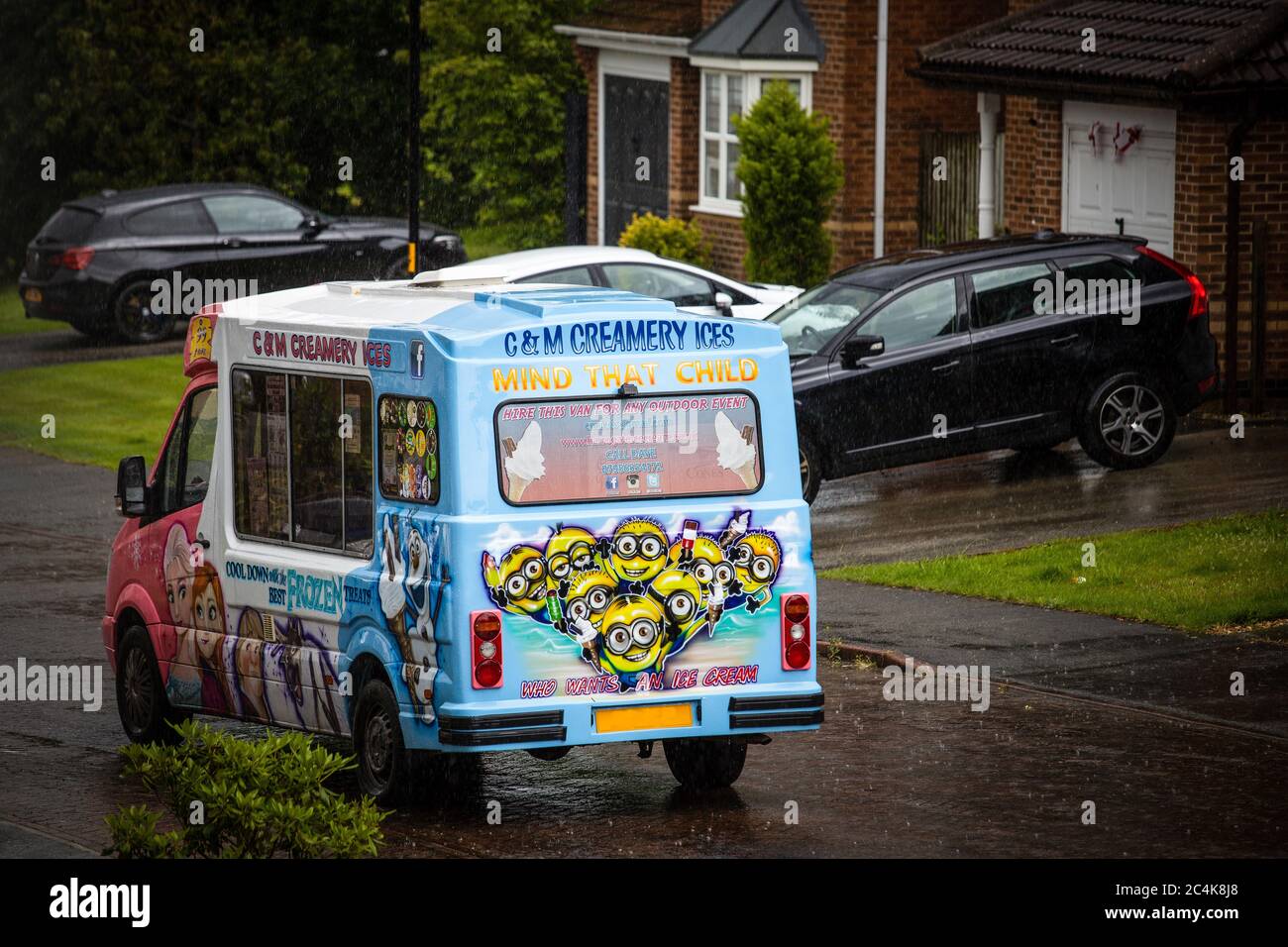 An ice cream van waiting patiently for the rain to stop on a wet rainy