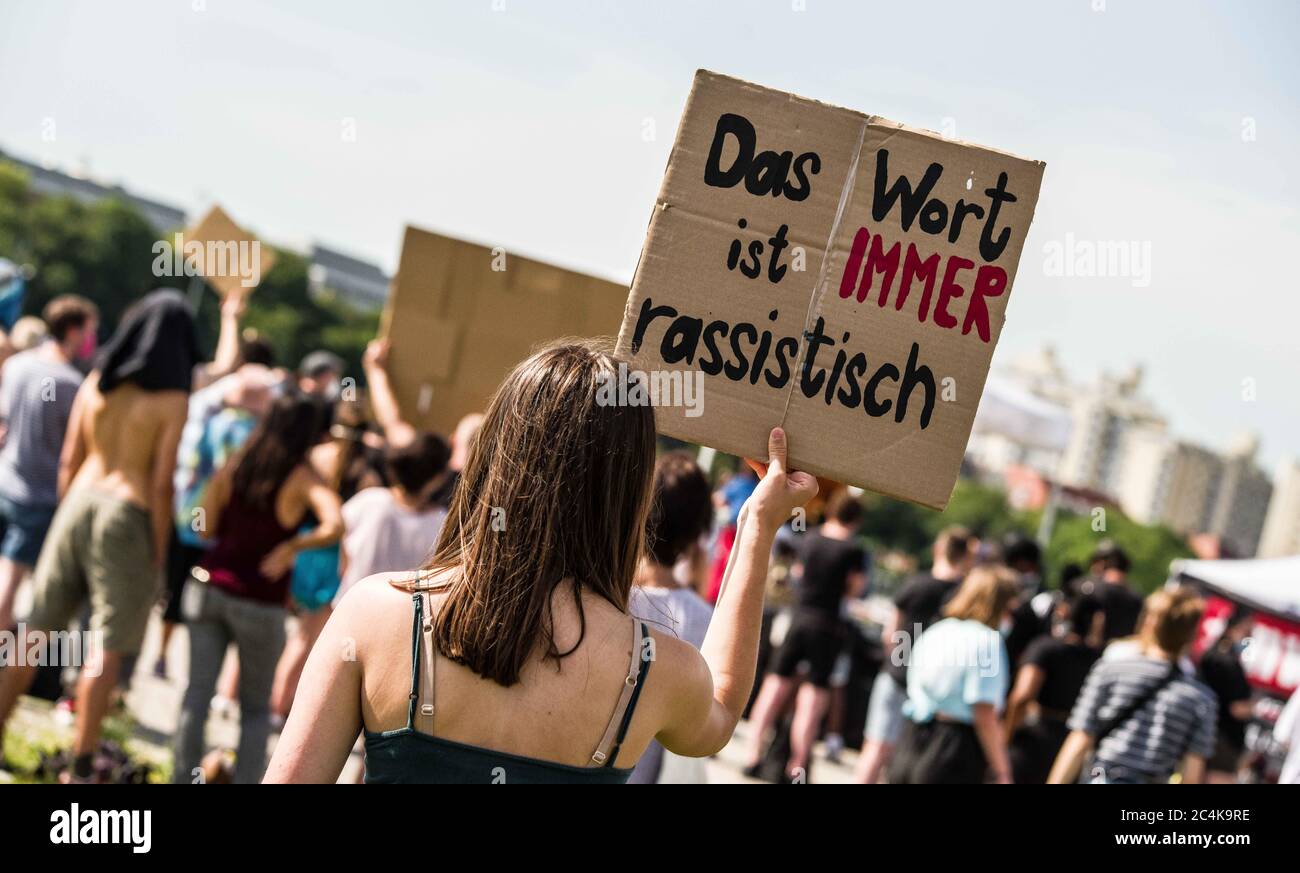 Munich, Bavaria, Germany. 27th June, 2020. ''The word is always racist'' held by a demonstrator against the ongoing use of the N-word in Germany. In the wake of the killing of George Floyd and numerous other cases of police brutality and killings against People of Color, over 500 assembled in Munich, Germany to protest against the use of the so-called N-Word. In Germany, the continued use of the N-Word is defended by mainstream politicians, police, right-extremists, Pegida, Neonazis, and the middle of society, despite blacks stating the use is racist derogatory, and exclusionary. Recently, a Stock Photo
