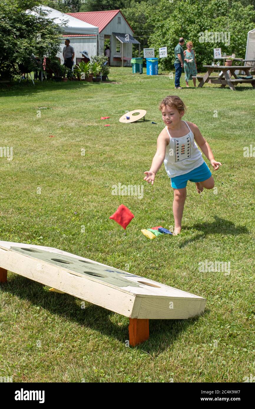 Little girl playing a game outside on a hot summer day Stock Photo