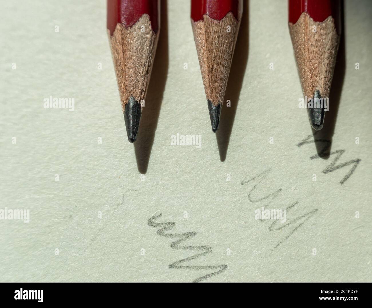 Close-up of three pencils placed on a notebook Stock Photo
