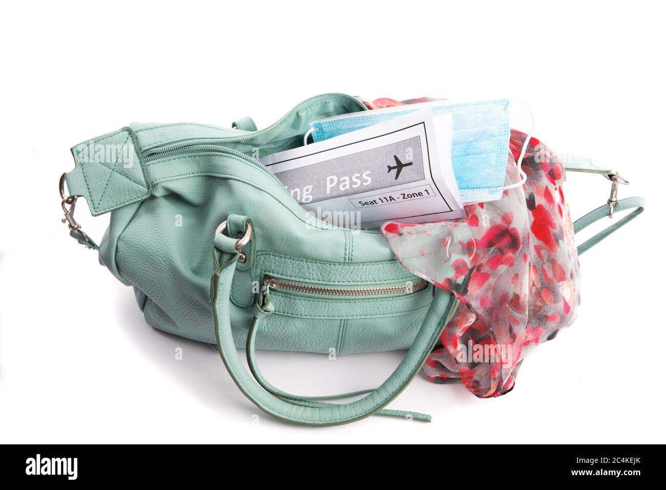 a boarding pass and surgical mask in a ladies hand bag suggesting the new  normal for air travel after covid-19 coronavirus Stock Photo - Alamy