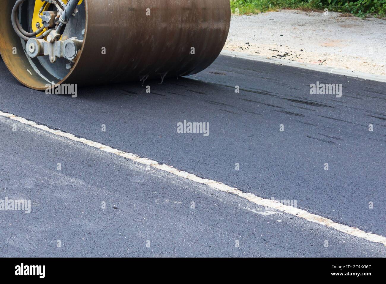 Fresh black asphalt on new street road. Construction at work. Stock Photo