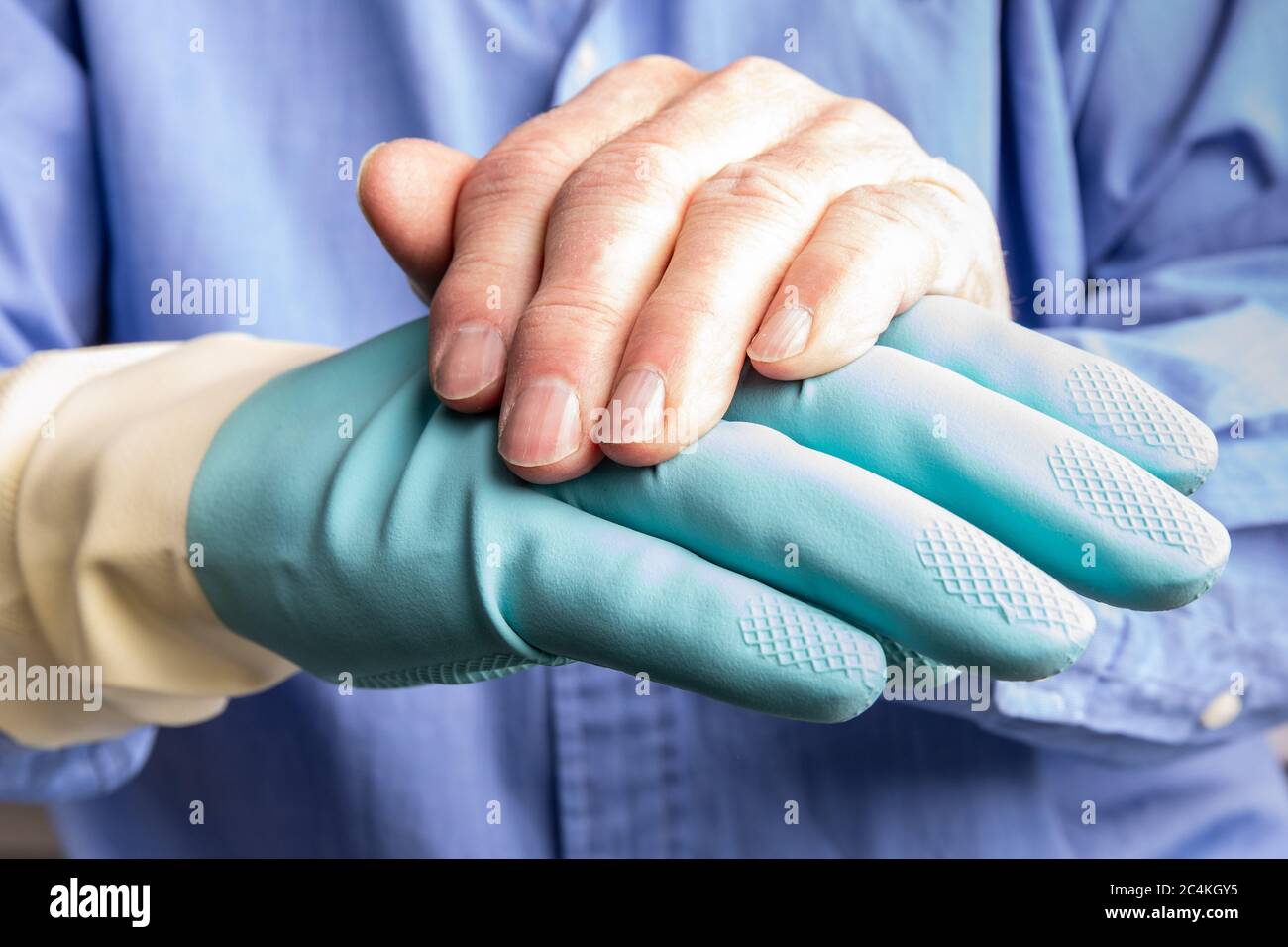 elderly hands putting on rubber gloves Stock Photo Alamy