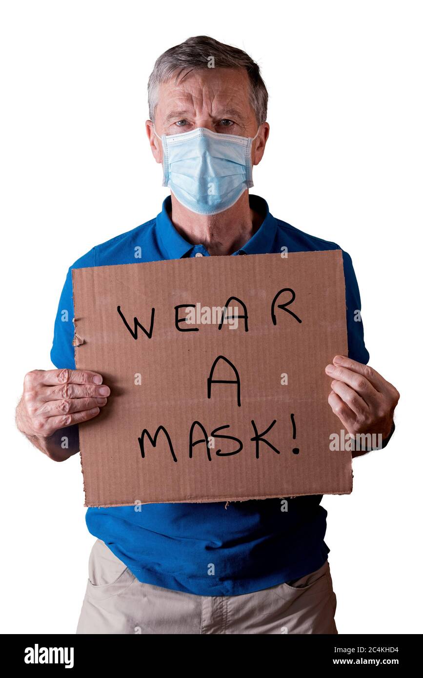 Senior caucasian man holding a blank cardboard sign saying wear a mask. He is isolated against a white background Stock Photo