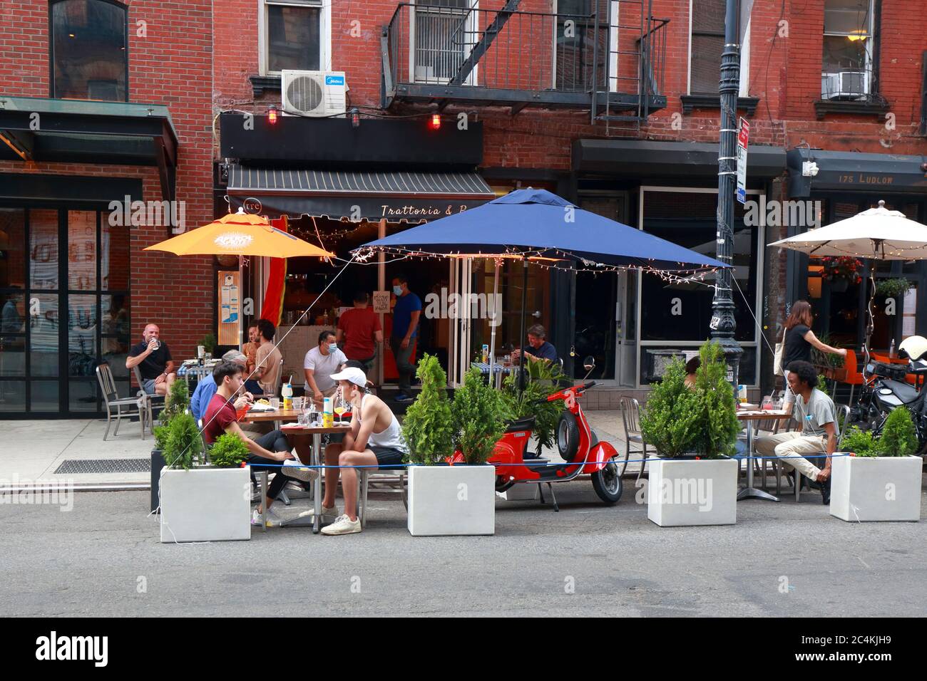 New York, NY. June 25, 2020. Socially distanced outdoor dining at Tre restaurant on Ludlow Street in Manhattan under Phase 2 reopening of New York City. Some restaurants and bars have expanded capacity by converting parking lanes into parklets, sidewalk extensions onto the roadway for dining and leisure, and not for car storage. Stock Photo