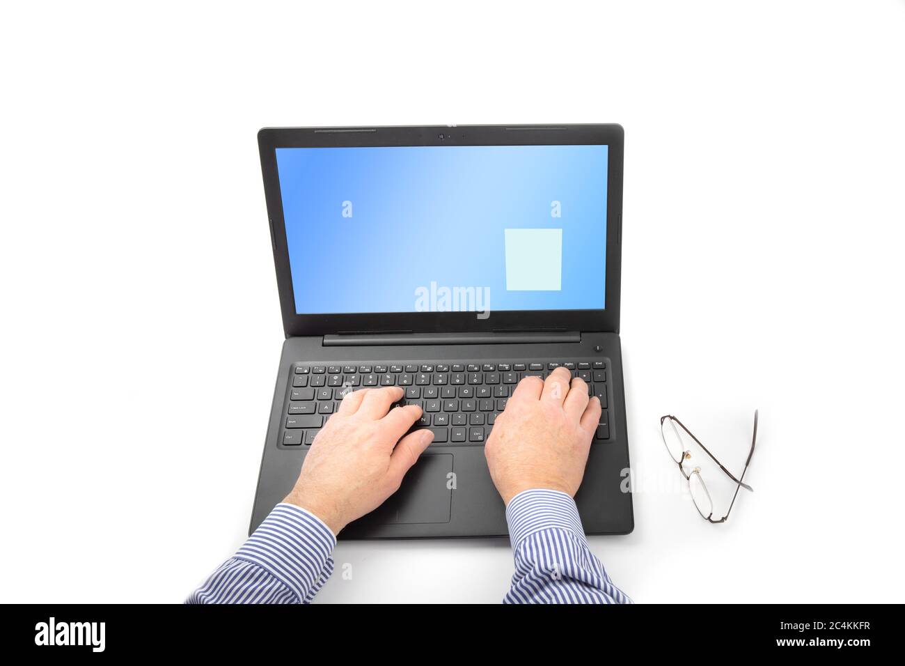 a man's hand on a notebook computer keyboard isolated on white Stock Photo