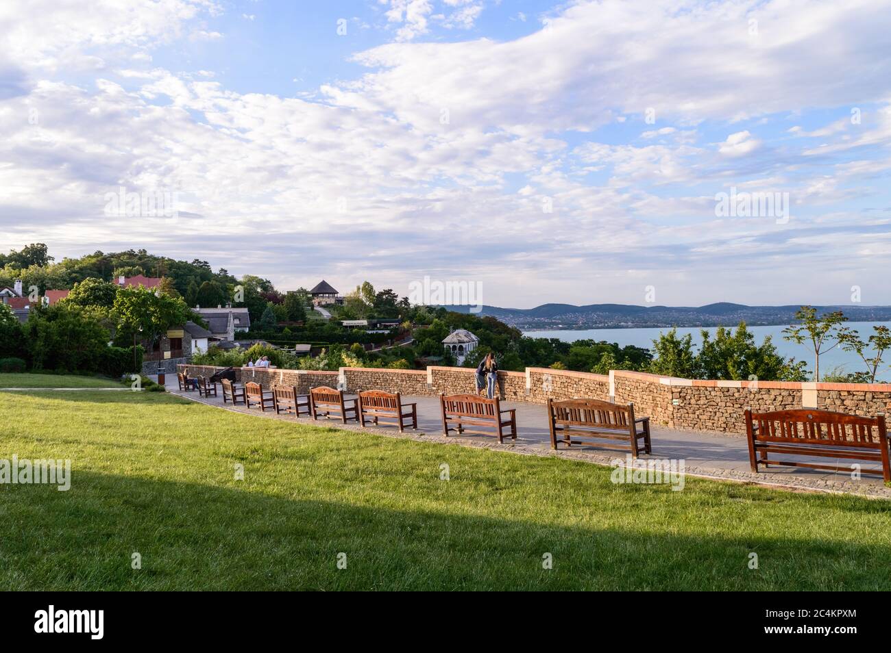 Tihany, Hungary - May 10, 2020: View from Tihany at sunset, with benches and people in the foreground Stock Photo