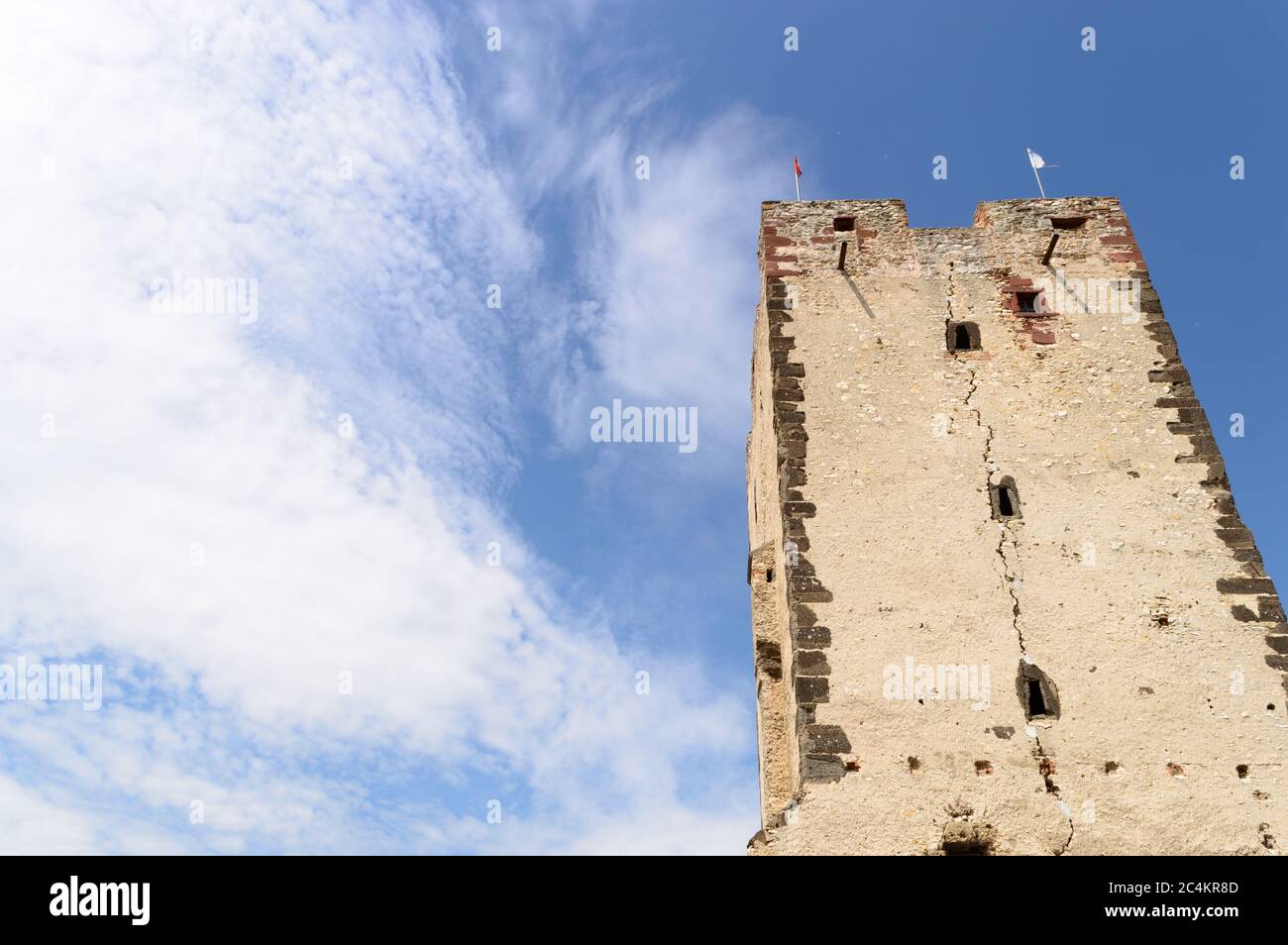 Low angle view of a medieval stone castle in Hungary in sunny weather with some thin white clouds Stock Photo