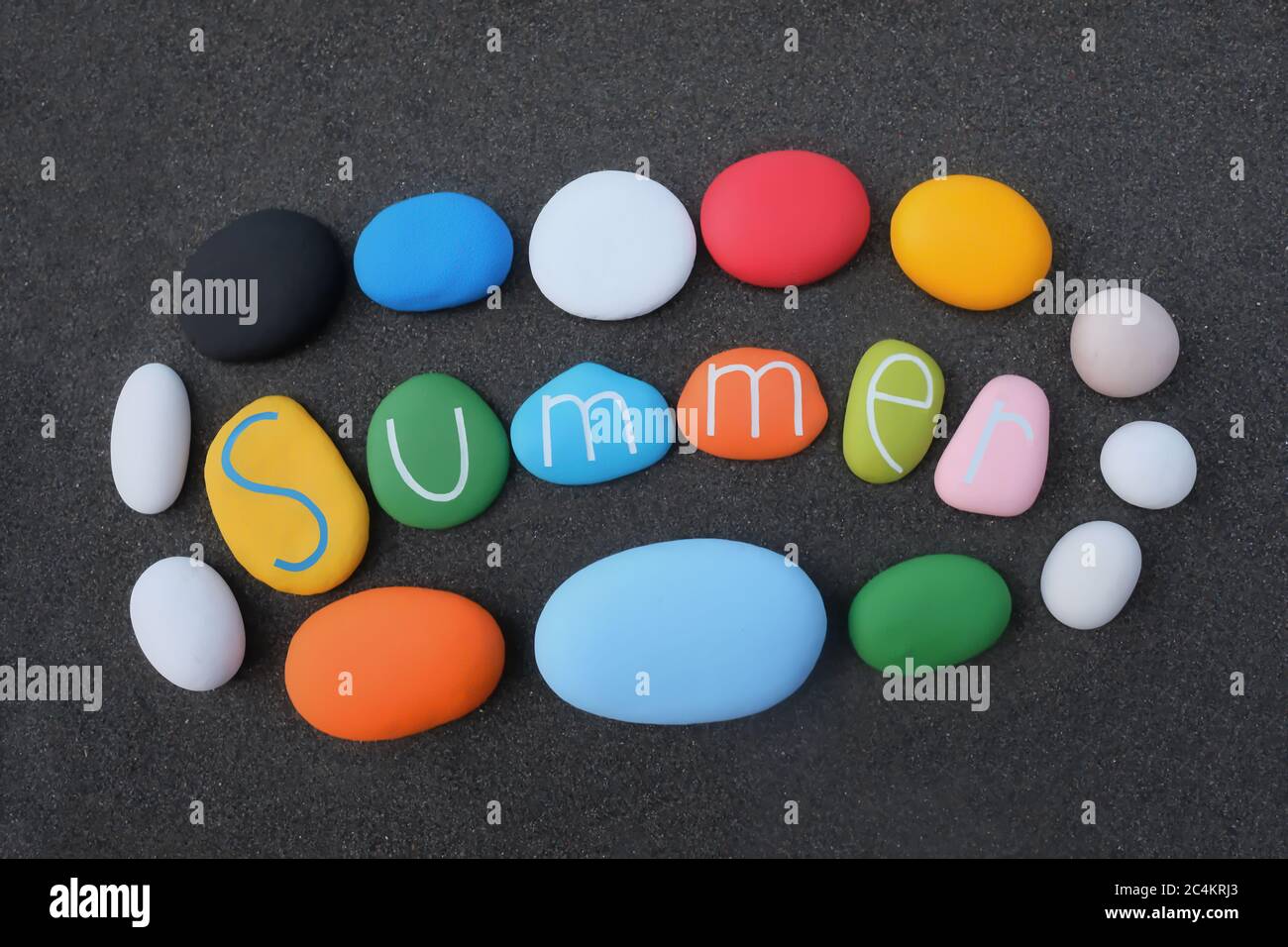 Summer text with multi colored stones over black volcanic sand Stock Photo