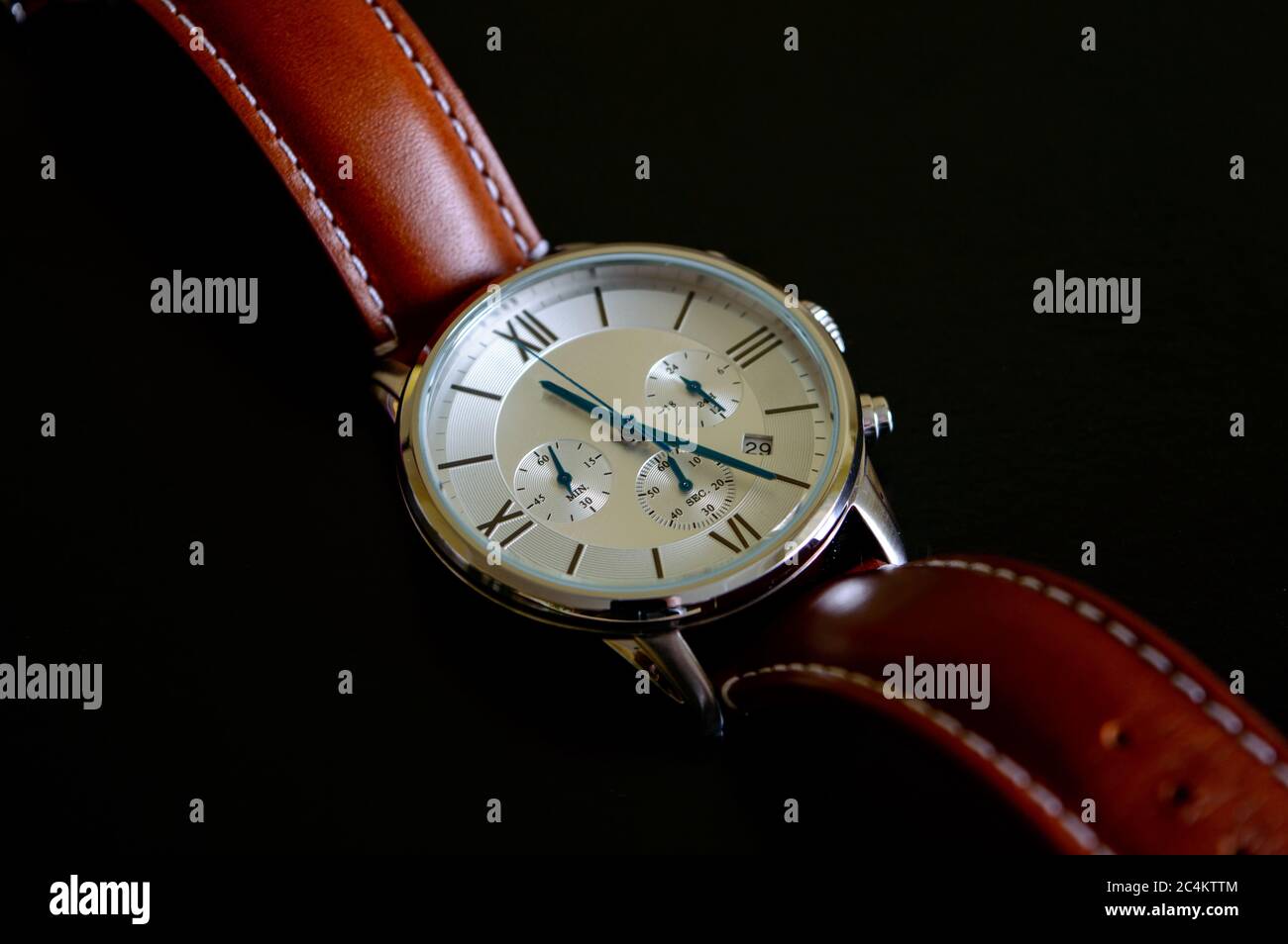 Nice luxury man's wrist watch with blue clock hands and brown leather ...