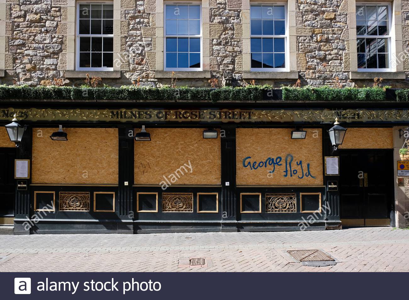 Black Lives Matter George Floyd spray painted on a boarded up Milnes Pub in Rose Street due to the Coronavirus Covid-19 lockdown Stock Photo