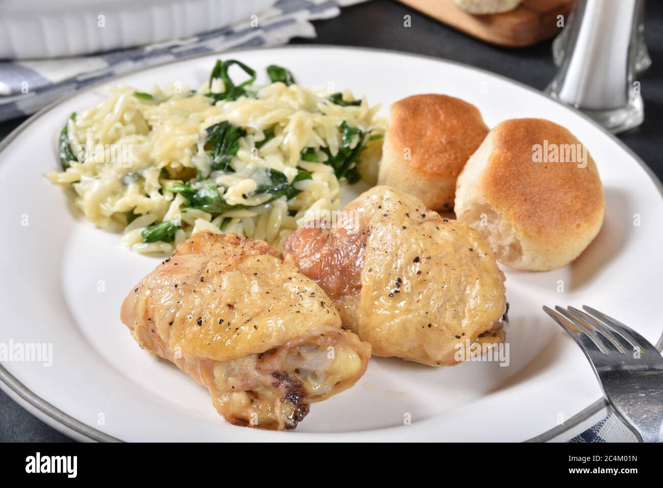 Fried chicken thighs with biscuits and spinach, parmesan orzo pasta