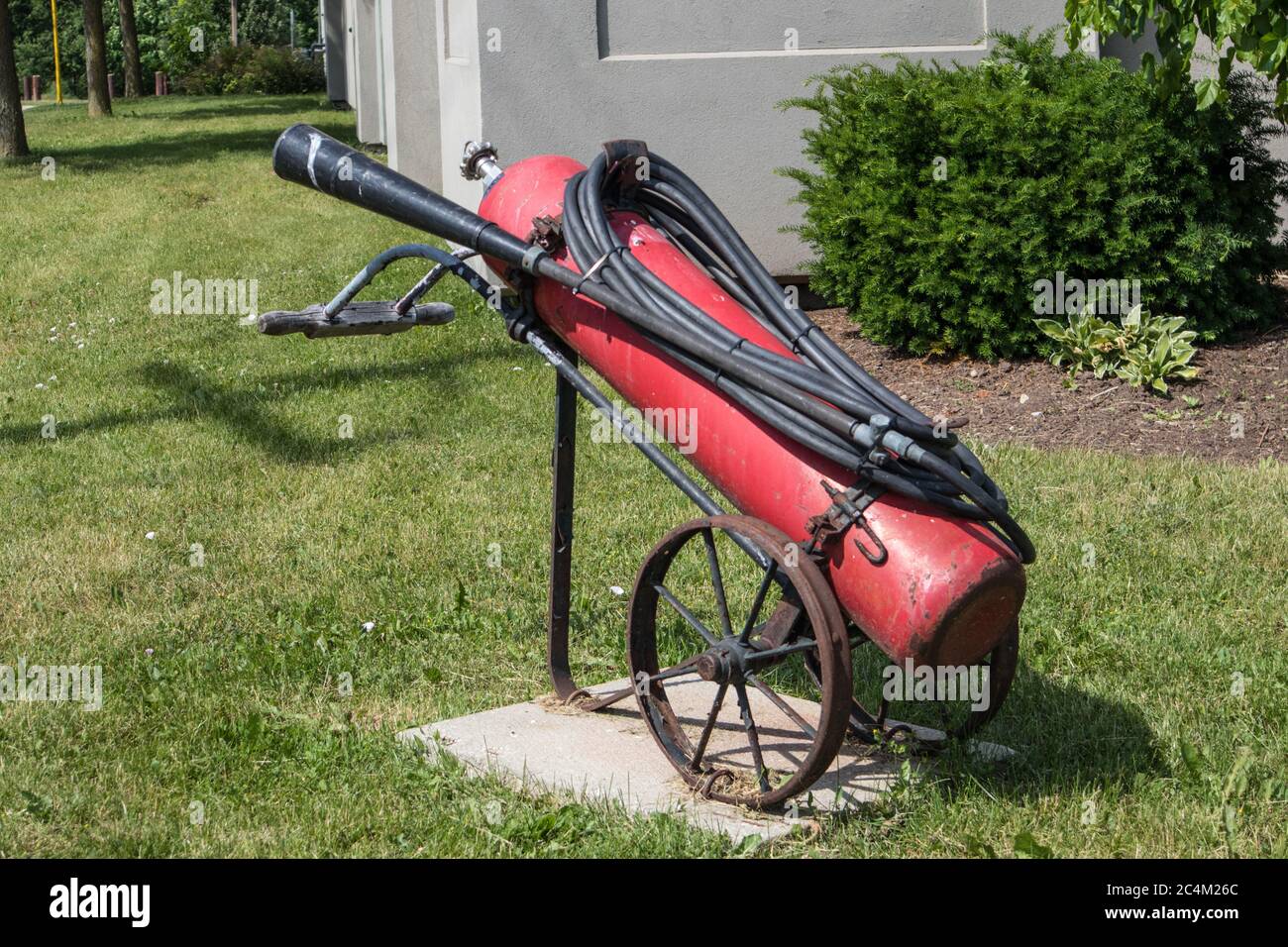 An antique fire extinguisher exposed outside the fire station Stock