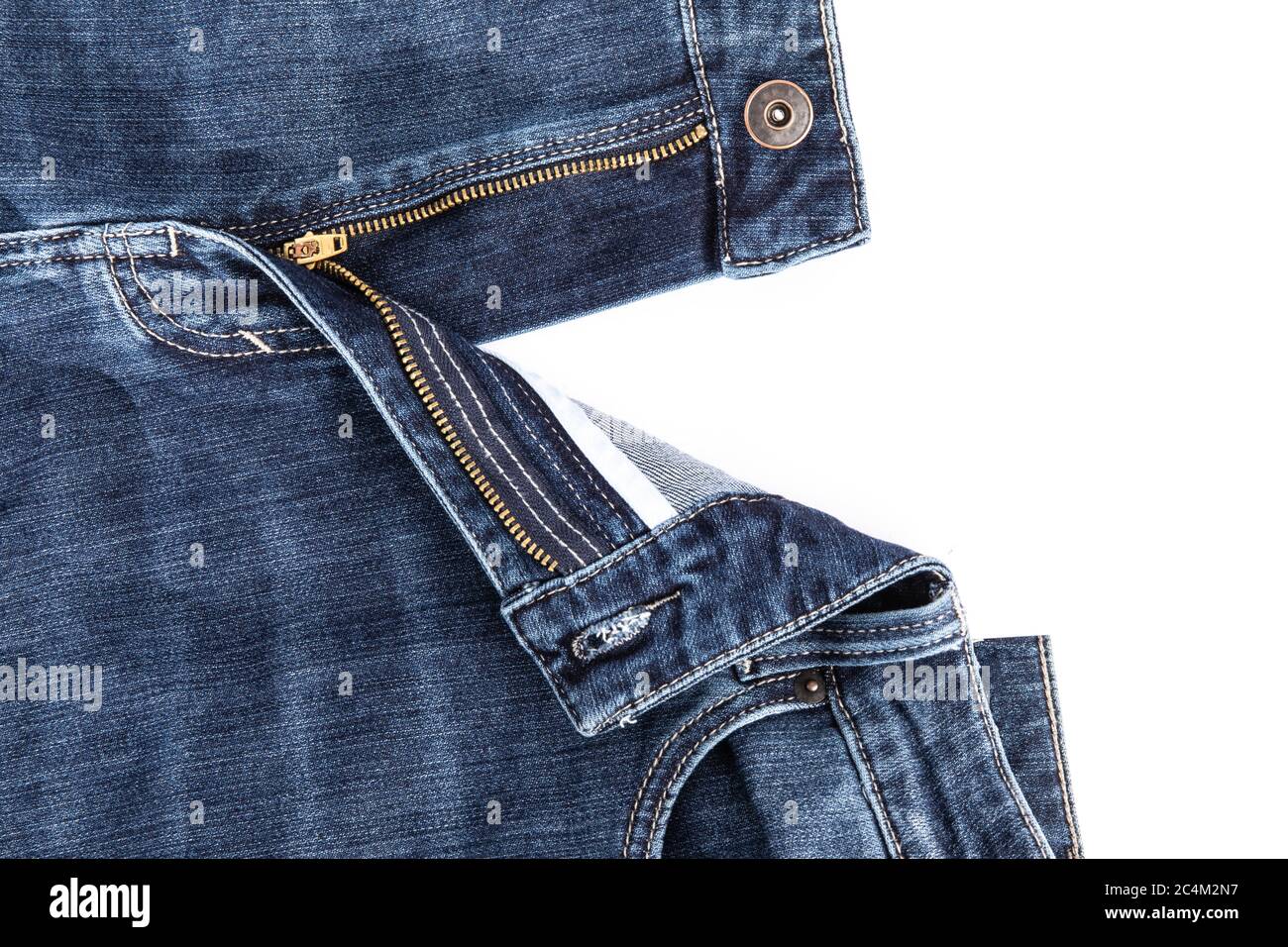 The open zipper of blue denim jeans open on a white background Stock Photo