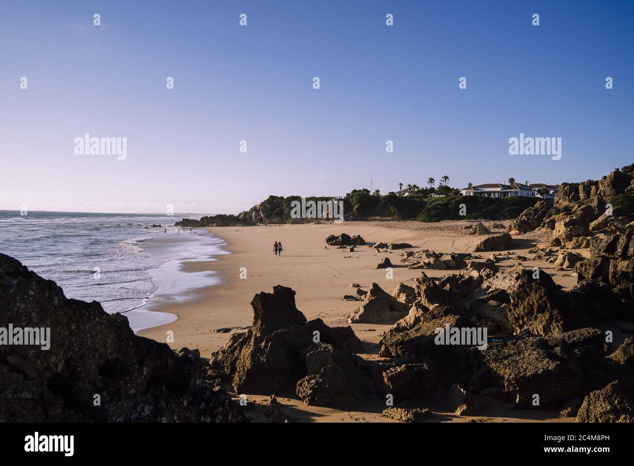 High angle shot of the rocks on the beautiful sand-covered beach by the ...