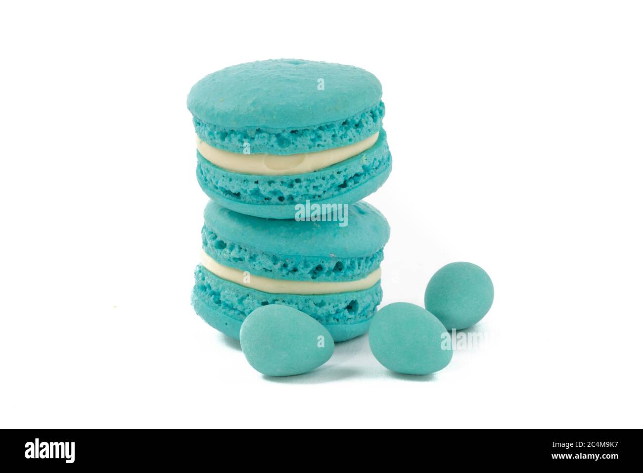 blue macaroon cookies and mini Easter eggs on a white background Stock Photo