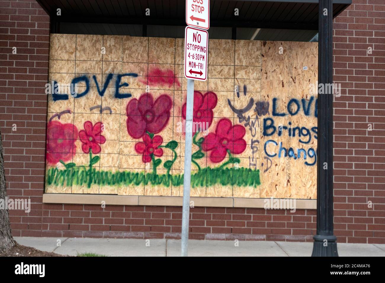 Walgreens boarded window with saying 'Love Brings Change' honoring the life and death of George Floyd Minneapolis Minnesota MN USA Stock Photo
