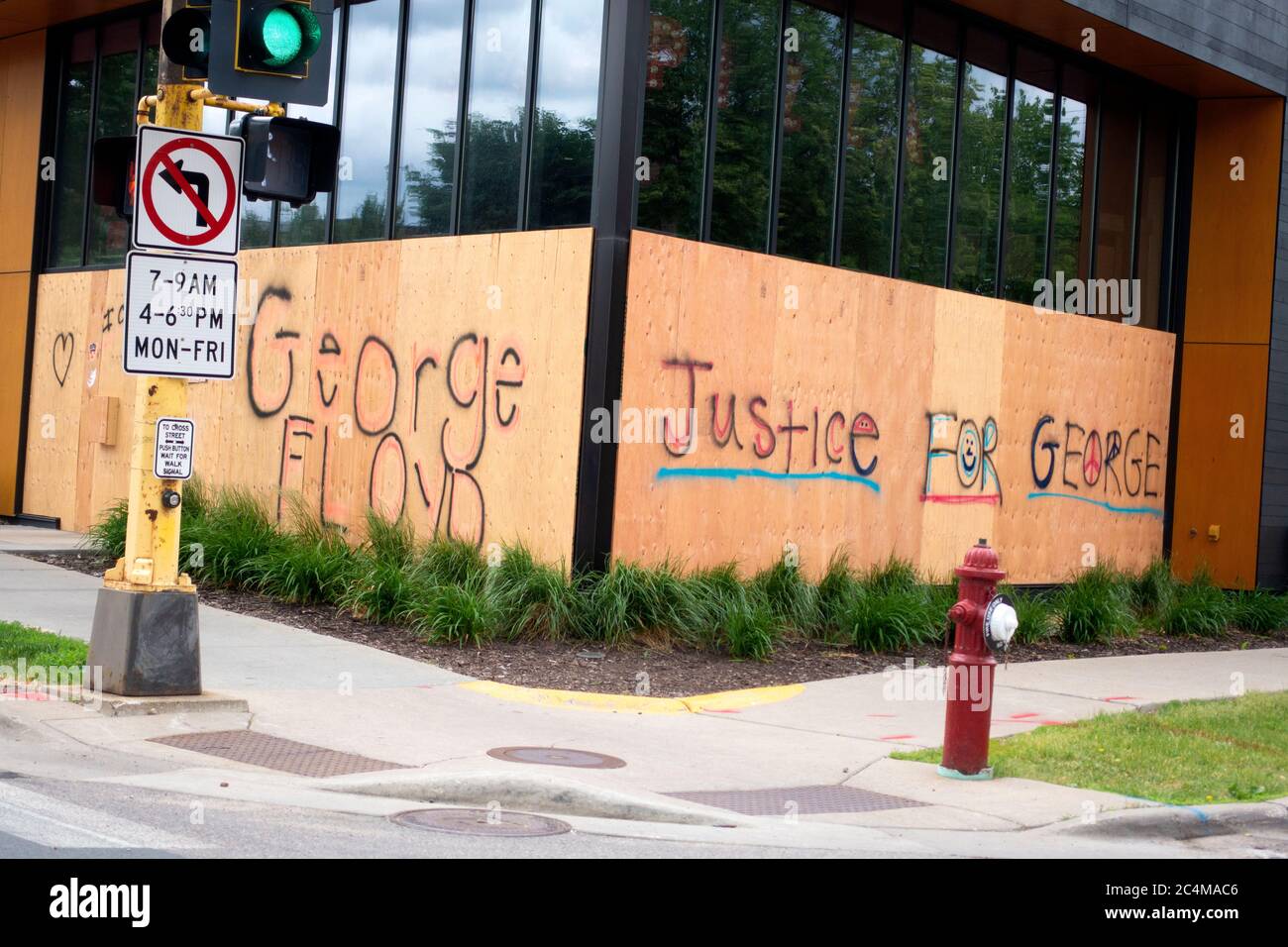 Justice for George printed with large letters on plywood window protecting against riots after the George Floyd death. Minneapolis Minnesota MN USA Stock Photo