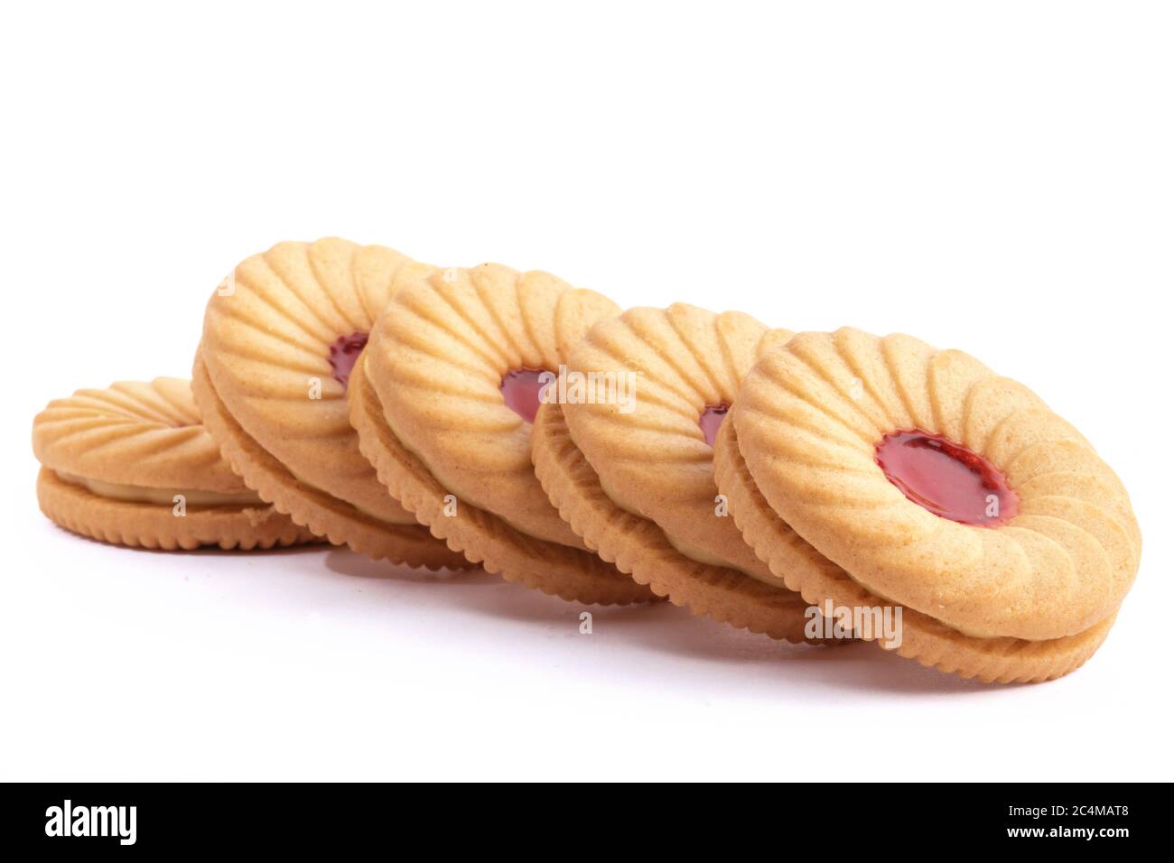 close up a line of strawberry fruit creme cookies isolated on white