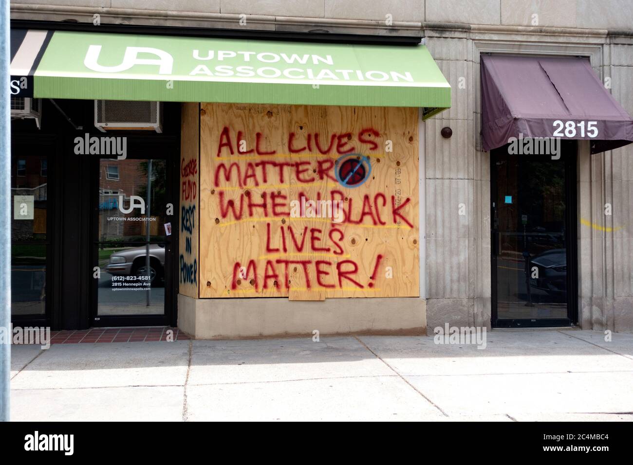 All Lives Matter when Black Lives Matter on plywood boarded windows of Uptown Association after George Floyd death. Minneapolis Minnesota MN USA Stock Photo