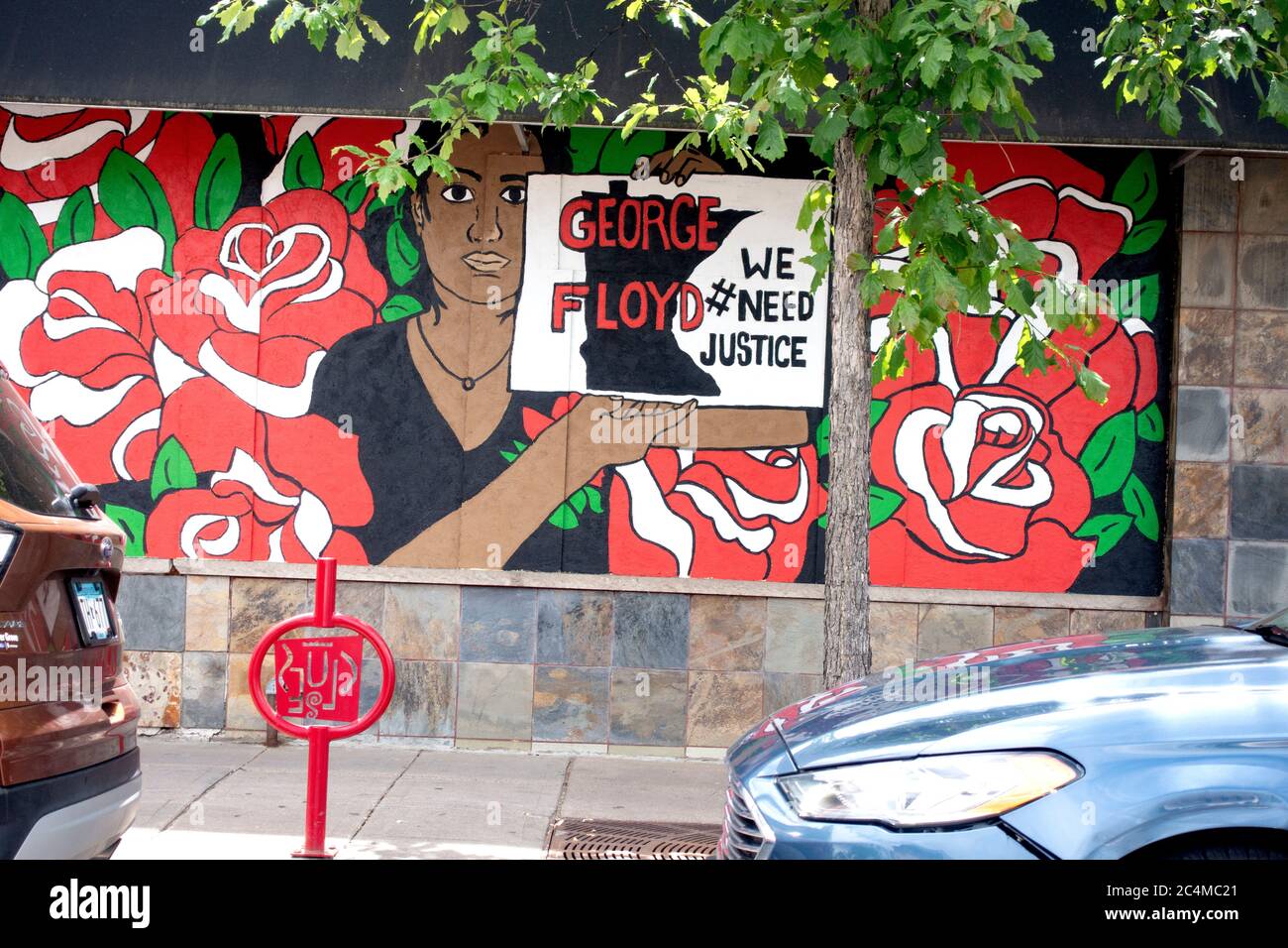 Hispanic business boarded up with mural and sign for George Floyd justice. Minneapolis Minnesota MN USA Stock Photo