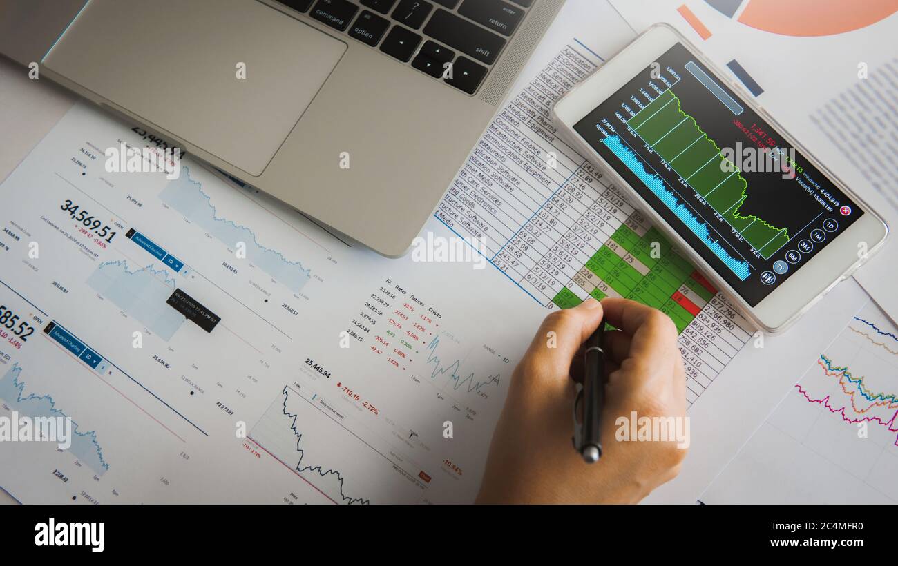 Businesswoman analyze business report graph and finance chart using ...