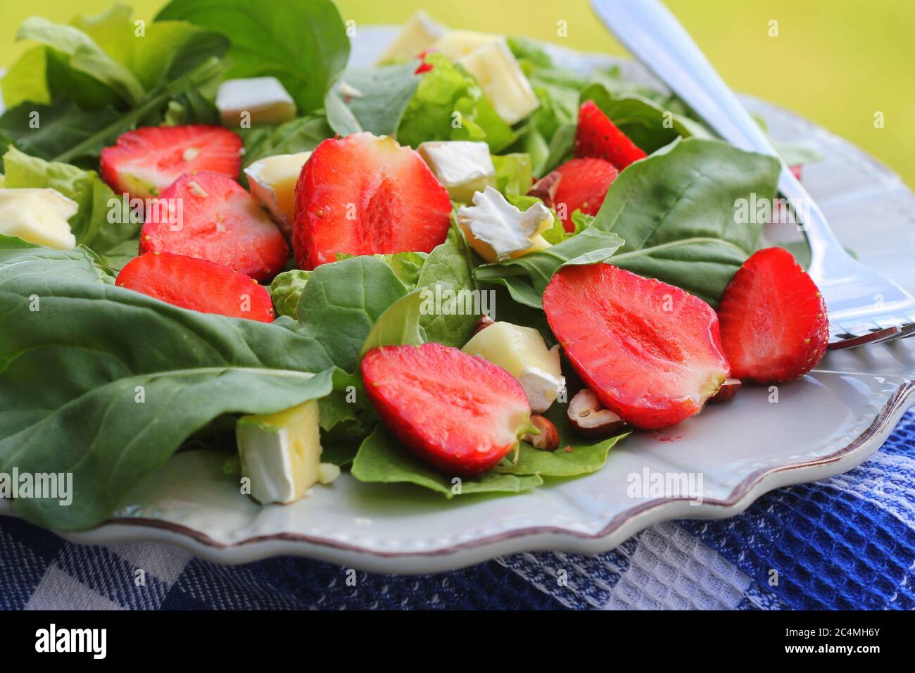 Spinach salad with strawberries,goat's cheese and nut Stock Photo Alamy