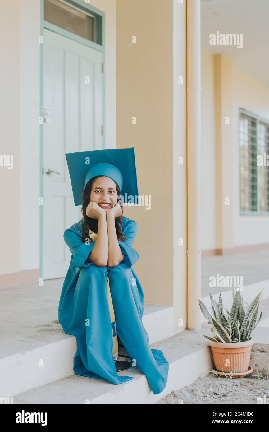 Portrait of a Filipino Woman wearing her Graduation cap, gown and Sash