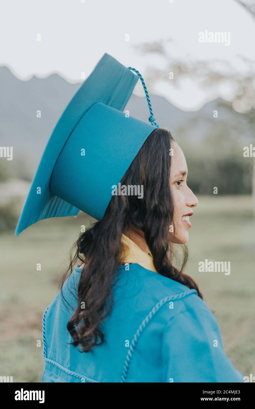 Portrait of a Filipino Woman wearing her Graduation cap, gown and Sash
