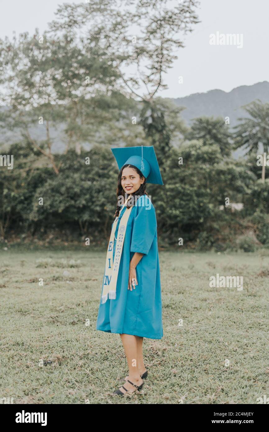 Portrait of a Filipino Woman wearing her Graduation cap, gown and Sash